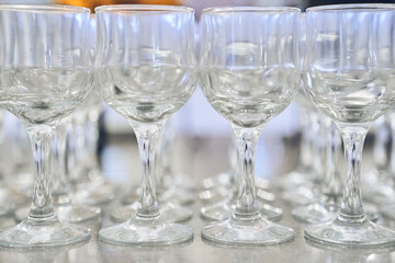 Close-up of a row of empty, transparent, clean wine glasses. With space to copy. High quality photo