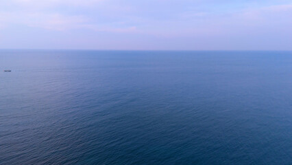 A drone shot of the beautiful sea scenery of Jeju Island, Korea, which boasts a green emerald cleanliness. Best healing trip. Harmony of basalt and waves
