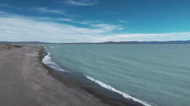 Beach & Mountains.Witness the magic where the ocean kisses the mountains. This drone video unveils Argentina's coastal paradise: a stunning fusion of turquoise waters, pristine beaches, and mountains.