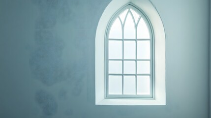 A narrow window with an elegant arch and clear glass on a stark white wall.