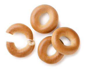 Dry bagels and broken in half on white background. Top view