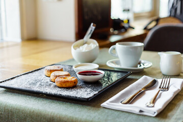photo of traditional rustic sweet bun cakes with cream cheese inside and powder sugar on surface.