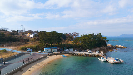 Fototapeta premium A photograph of beautiful sea and waves in the sky of the famous Numyeong Beach in Geoje Island