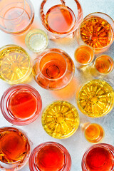 Assortment of alcoholic beverages: vodka, cognac, tequila, scotch, brandy and whiskey, grappa, liqueur, vermouth, tincture, rum. Strong alcoholic drinks. On a stone background.