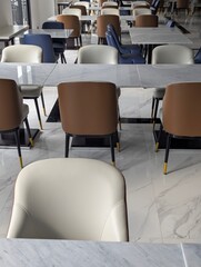 empty tables and chairs in the restaurant, A luxurious restaurant with an open-air atmosphere, featuring stunning views of the surrounding environment.