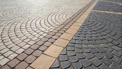 Fototapeta premium A closeup highlighting the transition between different sections of the plaza where the paving stones change from rectangular to circular seamlessly blending the two styles. The