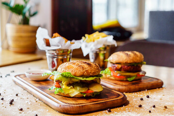 Craft beef burger and french fries on wooden table