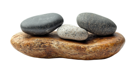 Set of smooth stones balanced on flat rock, natural harmony concept for spa, meditation, and relaxation themes isolated on transparent background