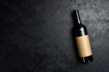 A bottle of wine on a black slate background. Top view. Free space for text.