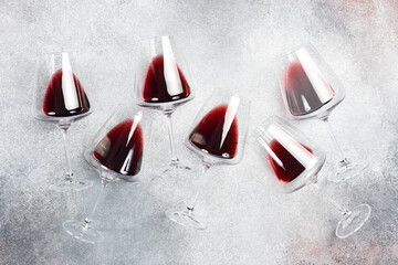Glasses with red wine on a concrete table. Wine glasses. Top view.