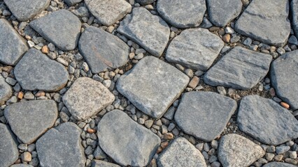 Obraz premium An overhead shot capturing the texture of a freshly laid gravel base highlighting the smooth even surface formed by the interlocking stones with some larger gravel pieces