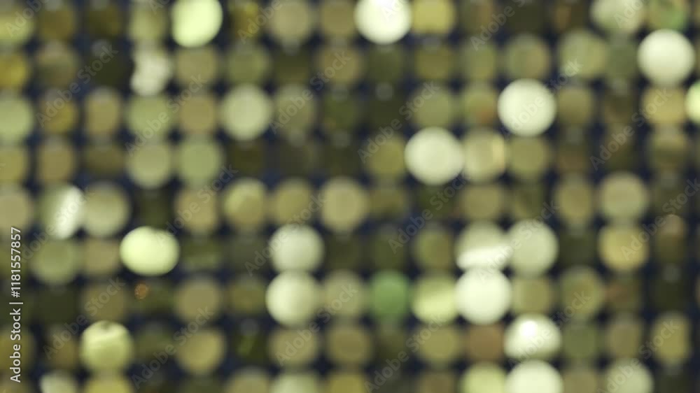 Poster A blurry image of gold and green dots. The dots are scattered all over the image, creating a sense of movement and energy. The image is abstract and has a dreamy, ethereal quality to it