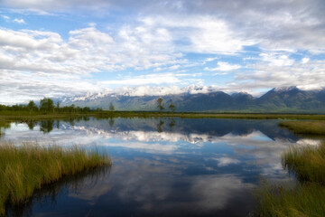 Russia. Landscape with mountains reflecting in the water on summer day. Buryatia, Tunkinskaya valley
