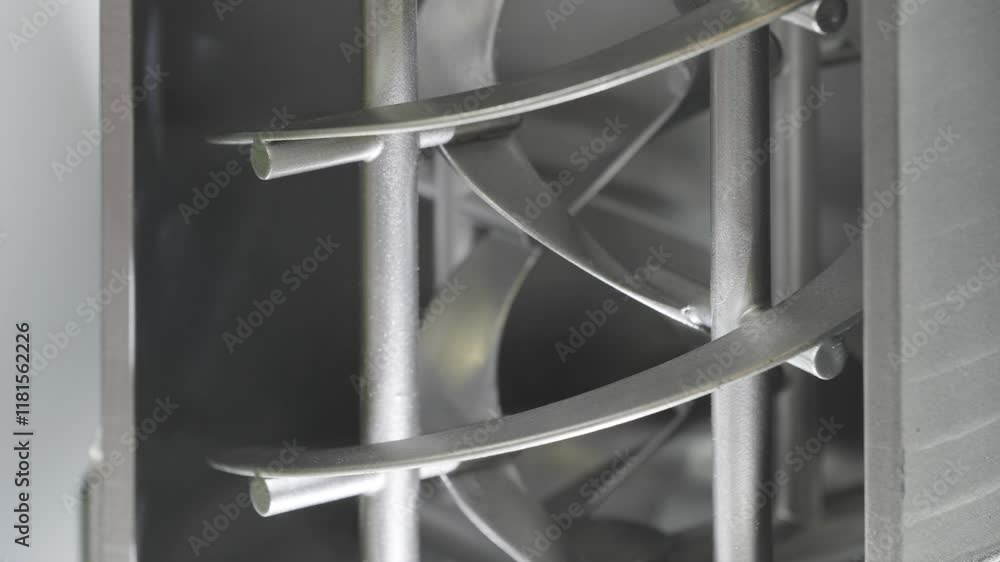 Poster a silver mixer machine with a spiral design. the machine is made of metal and has a silver color