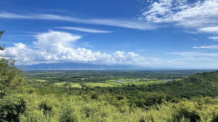 Obraz premium Breathtaking Panoramic View of Lush Green Fields and Wind Turbines
