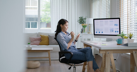 Young adult Gen Z asia people happy smile work from home office relax sit easy at cozy desk write note think idea plan self MBA study reskill upskill. WFH life balance online remote job on desktop PC. © ChayTee