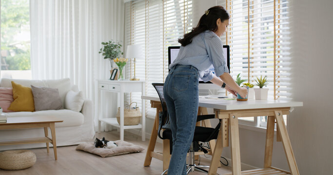 Future of workforce remote work fully permanent. Asia people happy relax move job to new small workspace set up desk picking file folder from box. Keep it chores neat start long term plan career work.