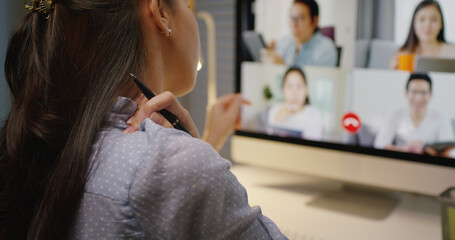 Young asia female busy late night work hard video call online remote group talk stiff neck relief...