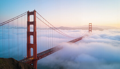 Fototapeta premium Golden Gate Bridge emerging from fog at sunrise
