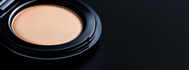 Cosmetic powder compact on black background.