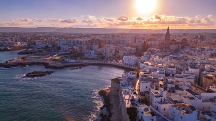 Aerial View of Monopoli, Italy: A captivating aerial view of  bathed in the warm glow of sunset.