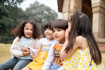 Cute Girl Whispering Secret In Her Friend Ear