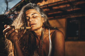 Beautiful shaman woman with pipes.