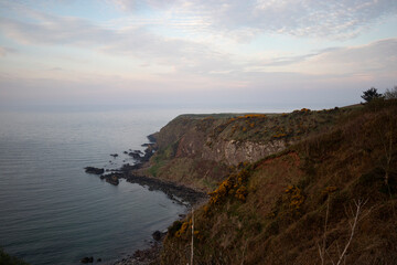 Picturesque coastline overlooking the calm waters of Stonehaven, Scotland during twilight hours