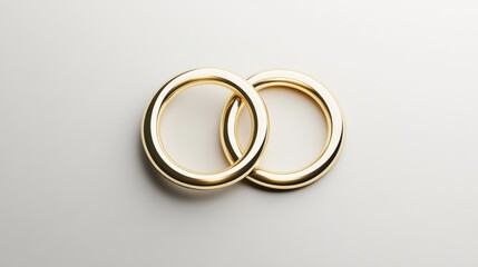Elegant pair of interlocking gold wedding rings on minimalist background