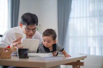 Father enjoys reading to his curious child at a cozy home setting in the morning light