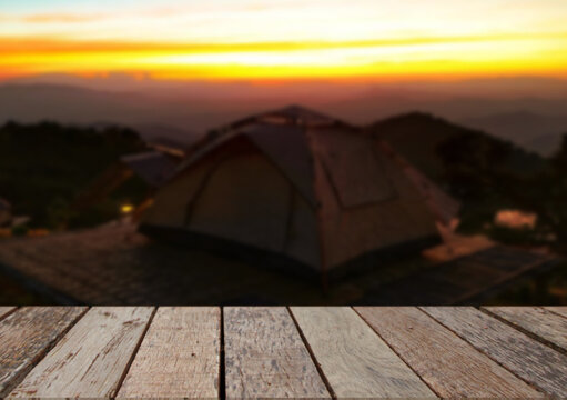 Wooden table top on camping ground mountain and grass field.Fresh and Relax concept.For montage product display or design key visual layout.View of copy space.