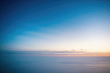 Fototapeta premium Serene sunset over a boundless ocean, painted with soft pastel hues across a tranquil sky.