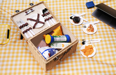 A wooden basket filled with some snacks and a cup of coffee