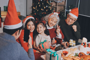 Happy family with gifts celebrating Christmas together
