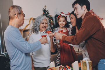 Merry Christmas! Happy family are having dinner at home. Celebration holiday and togetherness near tree.