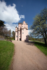 Craigievar Castle in Scotland showcases stunning architecture and idyllic surroundings on a sunny day