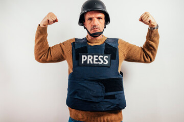 Reporter in bulletproof vest showing strong arms.