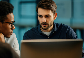 Two Colleagues Collaborating on Laptop