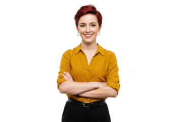 A young woman with short red hair, wearing a mustard yellow shirt and black trousers, standing with arms crossed and smiling confidently