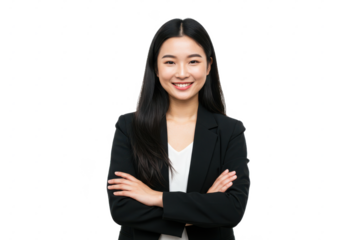 A young woman with long black hair, wearing a black blazer over a white blouse, standing confidently with arms crossed and smiling warmly