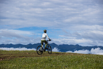 Fototapeta premium Riding mountain bike on beautiful mountain top