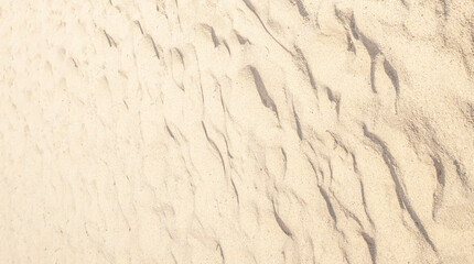 Summer beach sand background with natural wave pattern. Sand texture. Sunny gold sandy beach.