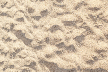 Summer beach sand background with natural wave pattern. Sand texture.