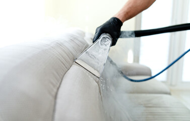 Cleaning concept. Sofa in the room. Virus prevention sanitizing inside. Process of deep furniture...