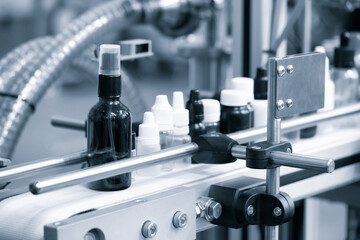 pharmaceutical industry, medicine pills are filling in the  bottle on production line machine conveyor at the medical factory. selective focus.
