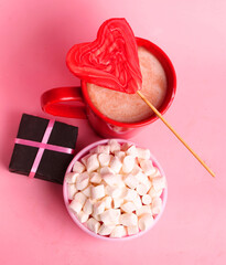 glass of hot chocolate with marshmallows and fire
