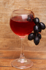 glass of red wine with grapes