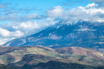 Fototapeta premium Snow topped mountains and green hills around Berat, Albania