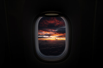 Fototapeta premium Airplane window view of clouds and sunset, serene and dreamy.