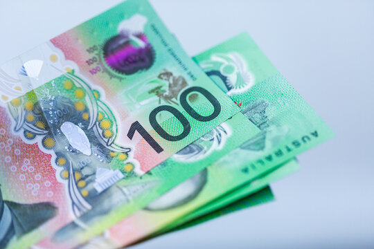 hundreds of dollars of Australian cash in green 100 dollar notes on white